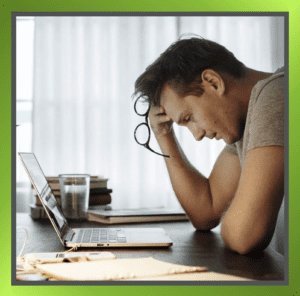 Person looking sad in front of a computer, symbolising loneliness in the workplace