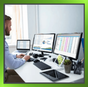 A person working on multiple computer screens, illustrating the concept of managing multiple jobs secretly in a home office setting