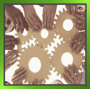 Hand coming together holding cogs the fit each other. This symbolises employee engagement.
