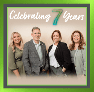 Four team members from Tick HR celebrating seven years of success at Tick HR Solutions in Lincolnshire.
