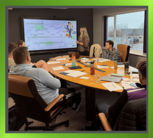 Professional trainer conducting a training session with a group of engaged employees in a modern workplace setting