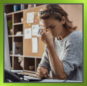 Portrait of a stressed woman seated at a desk