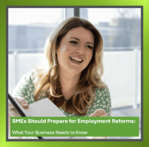 Businessperson studying documents about proposed employment reforms impacting SMEs, with charts and notes on a desk.