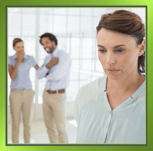 Person at work looking isolated or singled out, symbolising workplace bullying concerns.