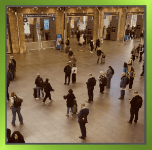 People walking through a busy train station, symbolising transition in employment rights reforms.
