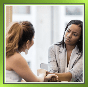 Two colleagues talking and listening attentively during a workplace conversation